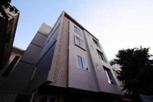a tall building with windows on the side of it at C'est La Vie Boutique Apartments by Le Pension Stays in Jaipur