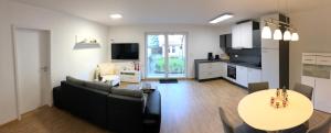 a living room with a couch and a table at Ferienhaus Eisenach in Eisenach