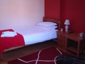 a bedroom with a bed and a nightstand and a bed sidx sidx at Red Lion Accommodation in Abingdon +3 photos
