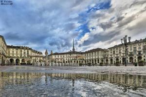 a city square with buildings and a cloudy sky at Albergo in Centro in Turin