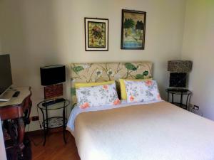 a bedroom with a bed and a desk and a piano at Crociferi B&B in Catania