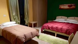 Postel nebo postele na pokoji v ubytování B&B LAVIKA PEDARA