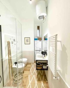 a bathroom with a toilet and a glass shower at Aphrodite Apartment Piazza Venezia in Rome