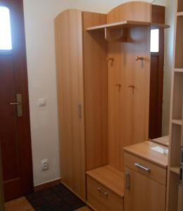a small kitchen with wooden cabinets and a door at Apartmán 4U Olomouc in Olomouc +7 photos