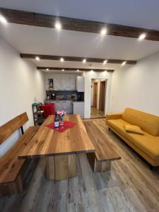 a living room with a wooden table and a couch at Gasthof Zum Ott in Staudach-Egerndach