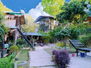 a park with a bench and a building at Bono Nibash Hill Resort in Bāndarban