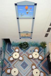 a bathroom with a tile floor with a painting on the ceiling at Best Western Hotel Bremen City in Bremen