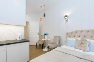 a bedroom with a bed and a table and chairs at La Boutique Studio Sopot in Sopot