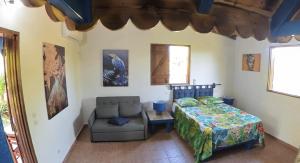 a bedroom with a bed and a chair at Maison de campagne toute équipée pour un moment de détente in Massioux