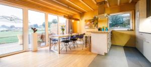 a kitchen with yellow walls and a table with chairs at Graues Haus in Monschau