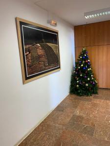 a christmas tree is sitting next to a wall at Apartman Jelen in Kaludjerske Bare