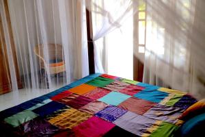 A bed or beds in a room at Mango Tree House