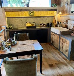 a kitchen with a table and a counter with a sink at Le Loft ATELIER in Fauvillers