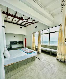 a bedroom with a bed with a view of the ocean at Funky Hotel in Hikkaduwa