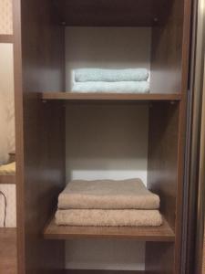 a shelf with towels and towels on it at Beautiful Guest House Qusar in Qusar