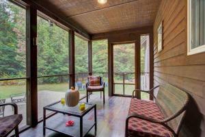a screened in porch with a table and chairs at Amazing Acorn in Diamond Point