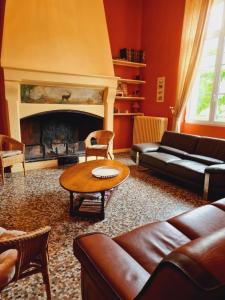 a living room with a couch and a fireplace at Gite d'exception, la Carrière l'Evêque 9 chambres 15 personnes, 100km de Paris en Exclusivité in Septmonts