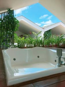 a white bath tub sitting in front of a house at EL Suites Canggu in Canggu