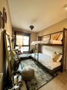 a room with two bunk beds and a rug at LOVPLAYA Almuñecar Beach Apartment in Almuñécar
