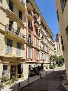 an empty street in front of a large building at Top floor nest, balcony close to sea and old-town in Nice