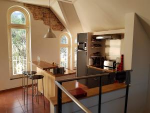 a kitchen with a stainless steel refrigerator and a counter at Loft in Borgloon in Borgloon