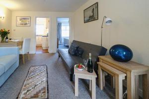 a living room with a couch and a table at 1 Coastguard Court in Aldeburgh +7 photos