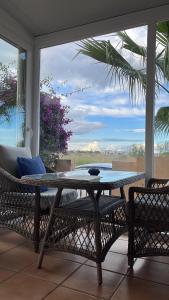 a table and chairs on a porch with a view at Casa Nuez Moscada in Villamartin
