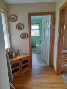 a hallway with a door open to a bathroom at THE LAKE HOUSE: a delightful and peaceful retreat. in Derrymacash