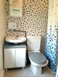 a bathroom with a toilet and a sink at Bracken's Retreat in Lostwithiel