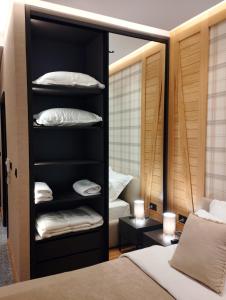 a bedroom with a black closet with white pillows at WILD BEAUTY Apartment-Modern mountain 2 in Kolašin