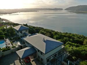 an aerial view of a house with a view of the water at Kanonkop House in Knysna