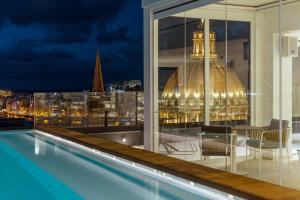 a view of the city from the balcony of a building at The Embassy Valletta Hotel in Valletta