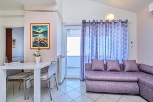 a living room with a couch and a table at Appartment Ksenija 1 in Mali Lošinj