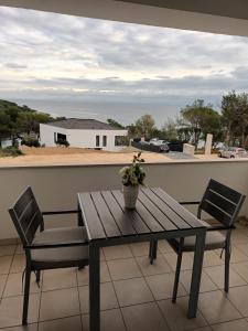 a table and chairs on a balcony with a view at Appartment Ksenija 1 in Mali Lošinj