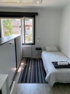 een kleine slaapkamer met een bed en een raam bij Omakotitalo, Raisio (near Meyer gate) in Raisio