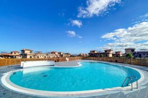 a large swimming pool on top of a building at Villa Origo Mare 1236 in Majanicho in Lajares