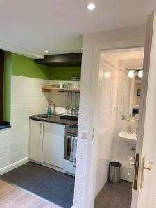 a small kitchen with a sink and a stove at Apartmenthaus Sonnen in Düsseldorf