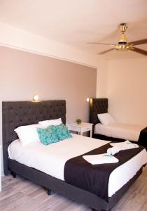 a bedroom with two beds and a ceiling at Hotel Terrazas by CPH in Villa Carlos Paz