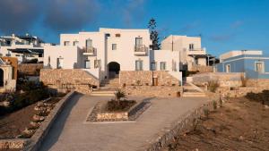 a group of white buildings on a hill with a street at MIKRES CYCLADES DONOUSSA in Donoussa