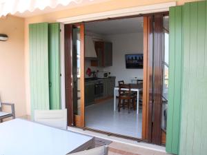 a sliding glass door in a kitchen with a table at Apartment in Lazise with Lake View Balcony in Lazise