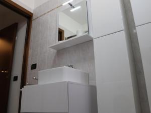 a bathroom with a mirror and a white sink at Apartment in Lazise with Lake View Balcony in Lazise +32 photos