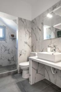 a white bathroom with a sink and a toilet at MIKRES CYCLADES DONOUSSA in Donoussa +39 photos