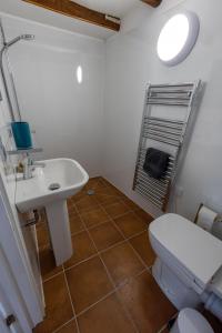 a bathroom with a sink and a toilet at The Wave - 3 bed beach front home in Sheringham in Sheringham