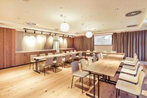 a conference room with wooden tables and chairs at Hafenhotel zu Putbus in Putbus +56 photos