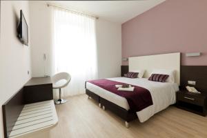 Postel nebo postele na pokoji v ubytování Hotel Centrale