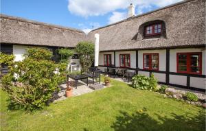 a house with a grass yard in front of it at Amazing Home In Sams With Wifi in Nordby