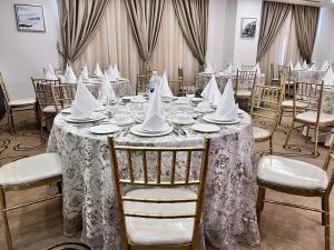 a dining room with a table with napkins on it at The Proud Hotel Al Khobar in Al Khobar