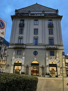 a large white building with a clock tower at Il Vecchio Borgo Relais in Como