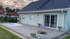 a blue house with a patio in front of it at Dom Anna in Pisz