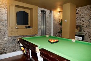 a room with a pool table in a room at Captivating 9-Bed House Hot Tub Near Cambridge in Saffron Walden